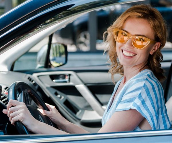 stock-photo-happy-woman-yellow-sunglasses-holding